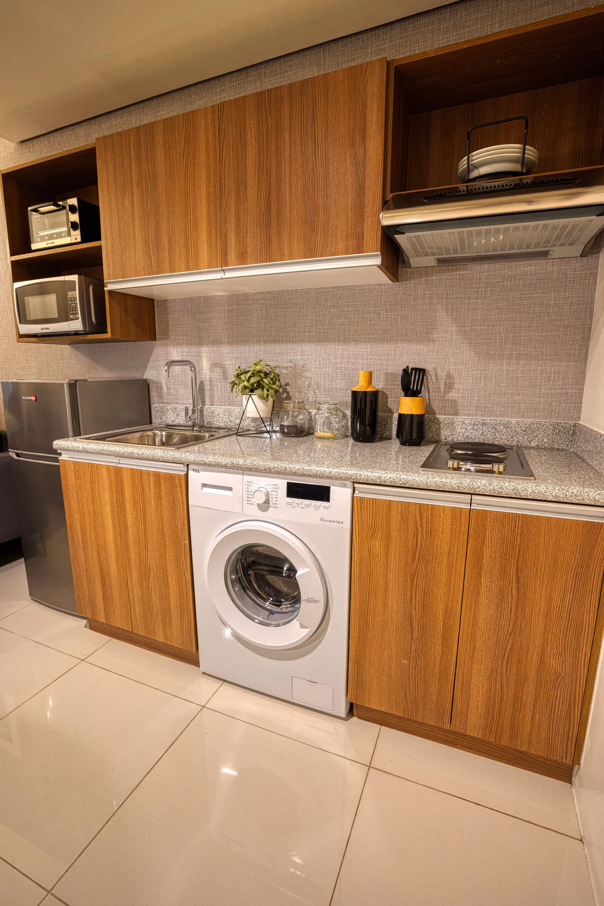 Contemporary kitchen with wooden cabinets and built-in laundry area at 3Torre Lorenzo.