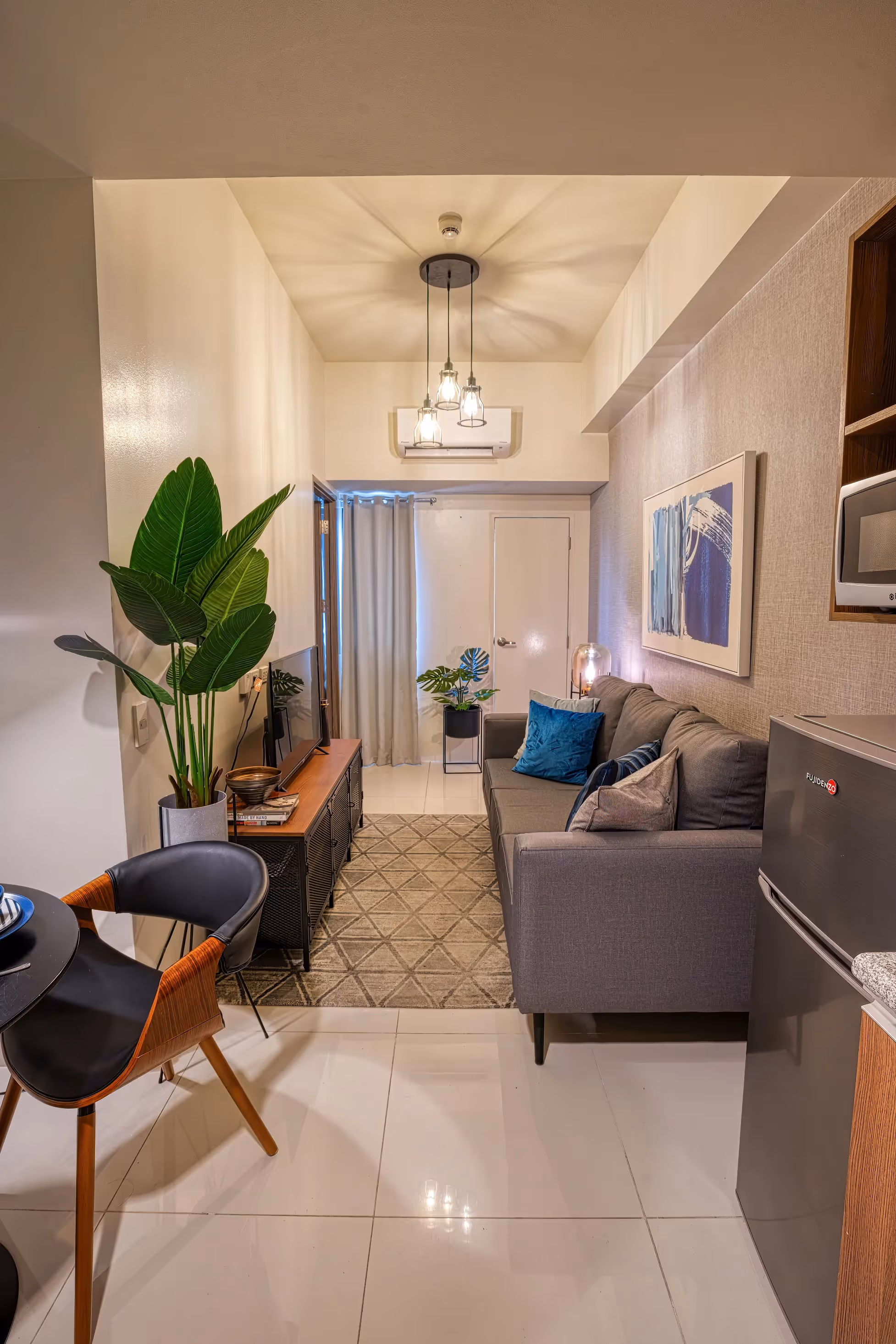 Stylish living and dining area with neutral tones and open kitchen at 3Torre Lorenzo.