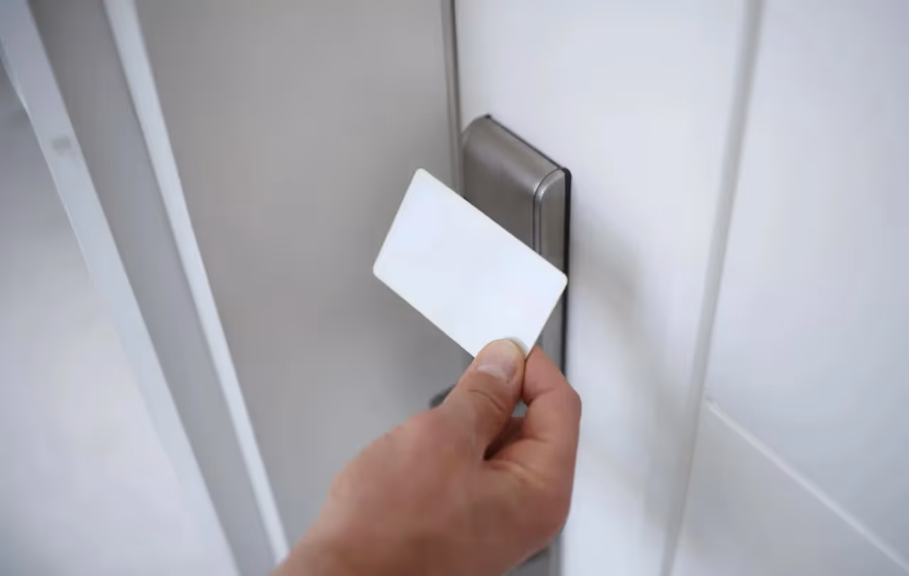 Hand tapping RFID card on electronic door lock