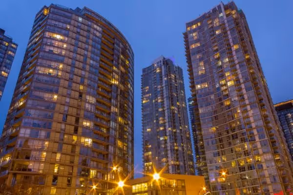 Residential high-rise towers at night with city lights