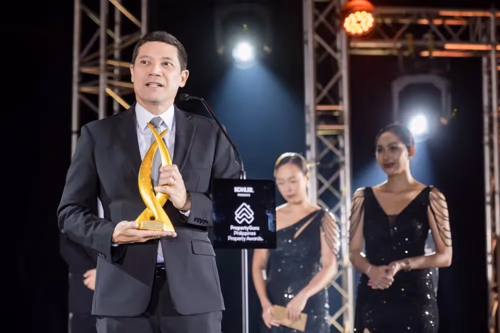 Executive holding award on stage at Philippine Property Awards ceremony