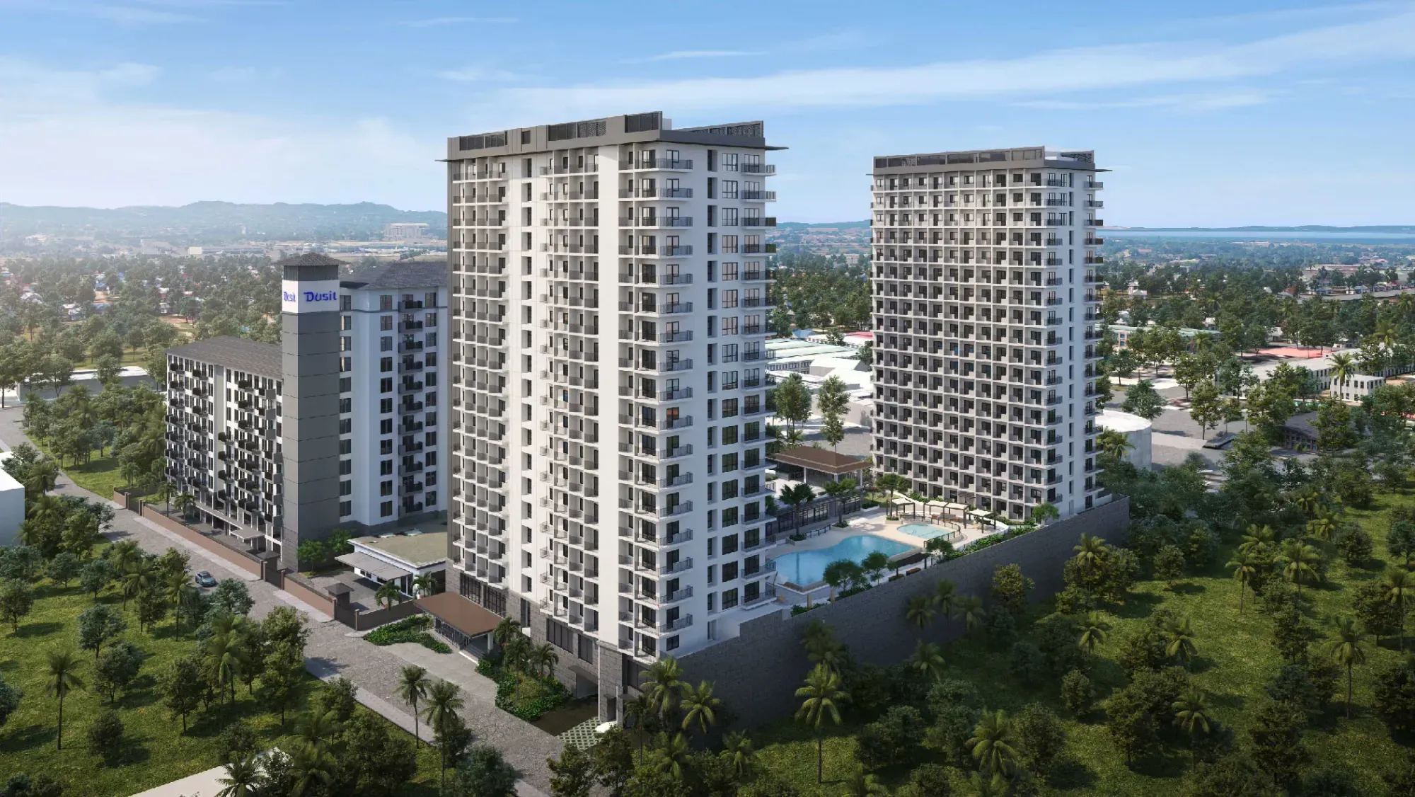 High-rise condominium towers with pool area surrounded by greenery.