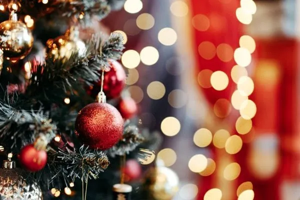 Close-up of decorated Christmas tree with red ornaments and lights