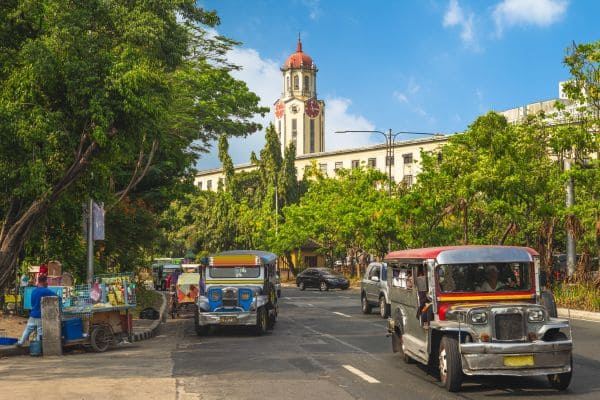 Street scene with jeepneys and a historic clock tower building