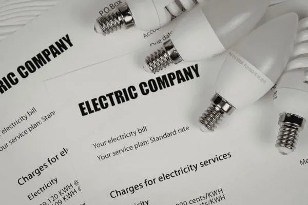 Electric company bills with energy-saving light bulbs
