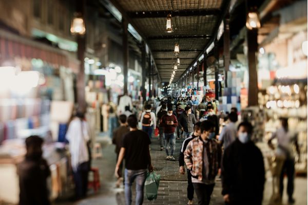 A bustling market in Davao, filled with people walking among stalls and vibrant displays of goods.