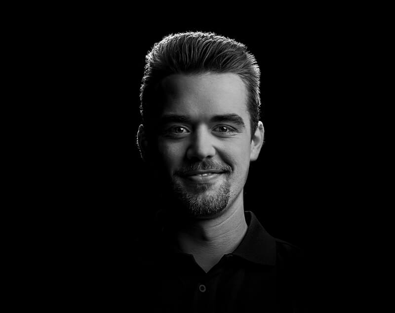 Headshot of team member Tobi smiling in a modern office, wearing smart-casual clothes