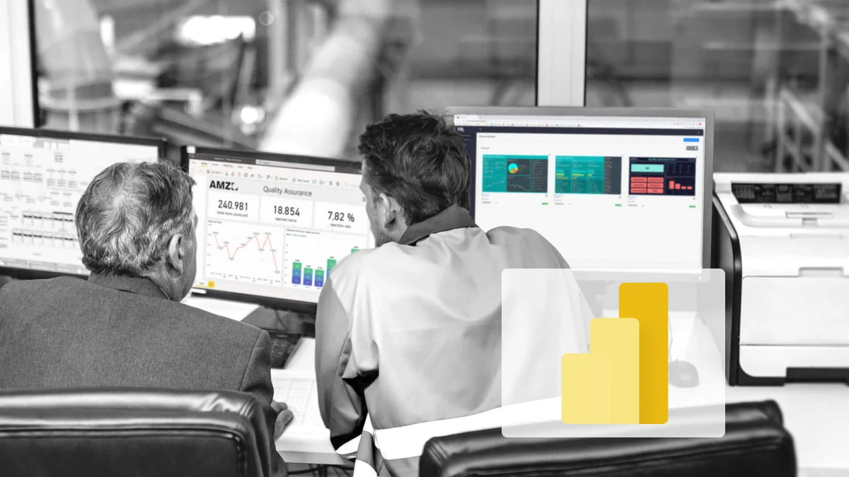 Two employees analyze production data on multiple monitors using Power BI and Peakboard dashboards — focusing on quality assurance and live key figures.