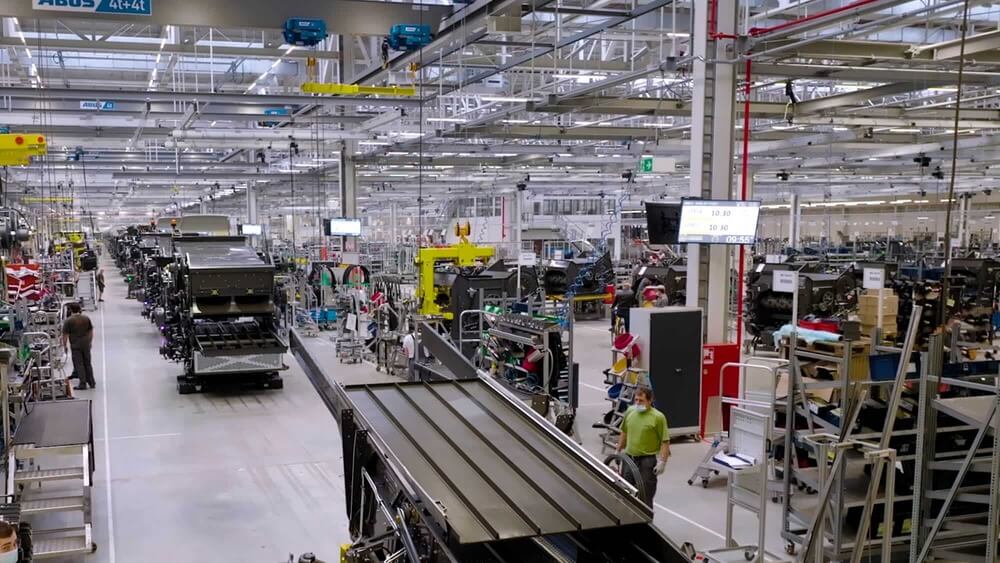 Production hall at CLAAS with assembly lines, machinery, and workers in agricultural equipment manufacturing