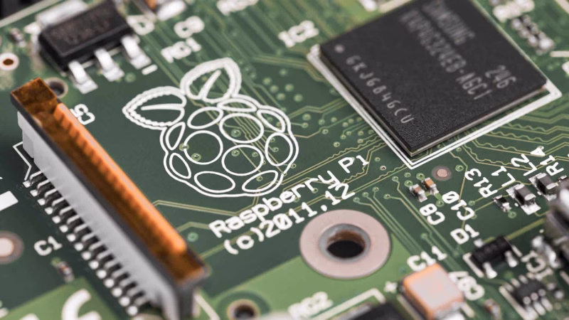 Close-up of a Raspberry Pi single-board computer with microchip and circuit tracks.
