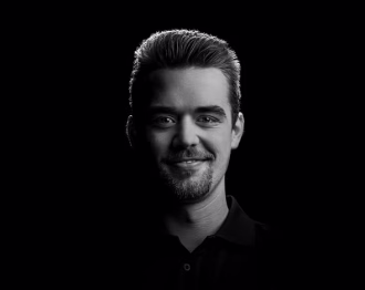 Portrait of Tobi, smiling teammate in the office.