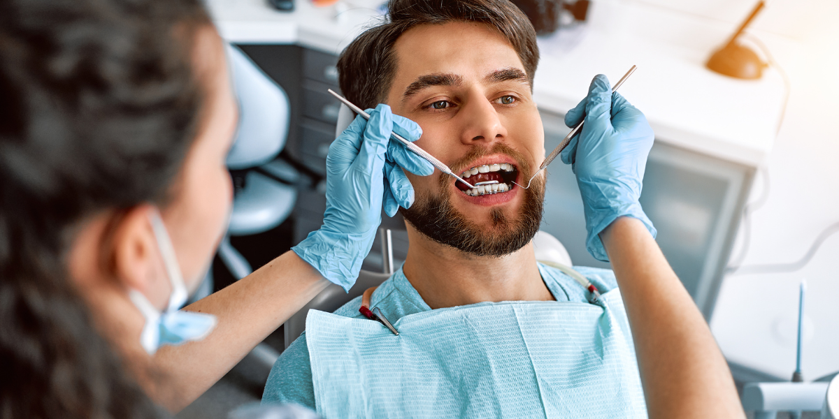 A dentist conducting a restorative dental procedure on a patient in a contemporary dental clinic, highlighting the principles of restorative dentistry.