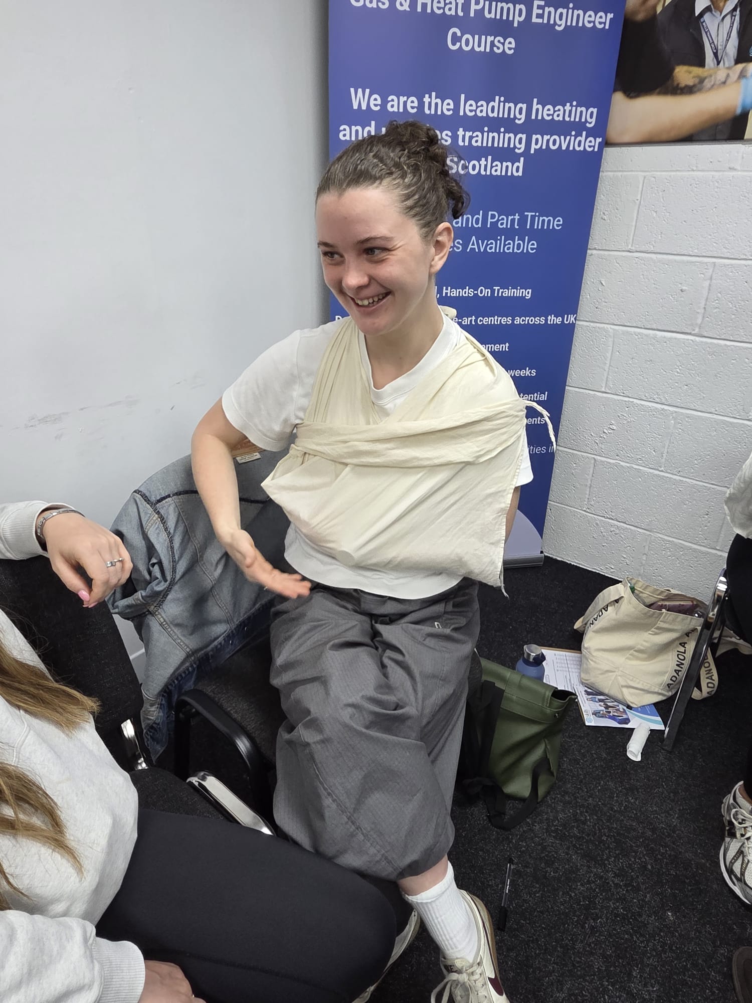A delegate practising sling and bandaging technique on a first aid course