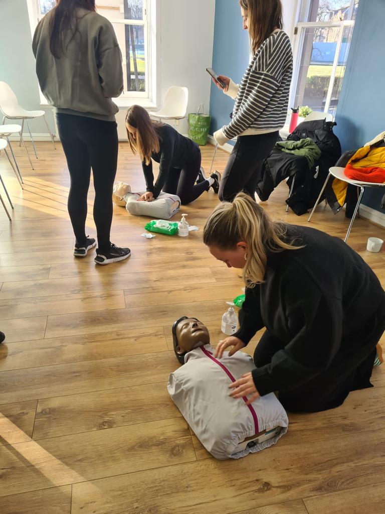 Practising CPR and defibrillator use on a first aid course in Leeds