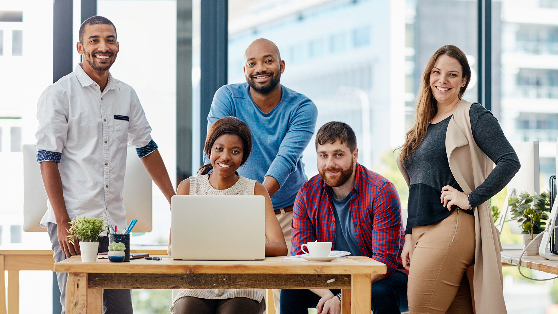 A mature male business owner reviewing paperwork while sitting at desk in an office