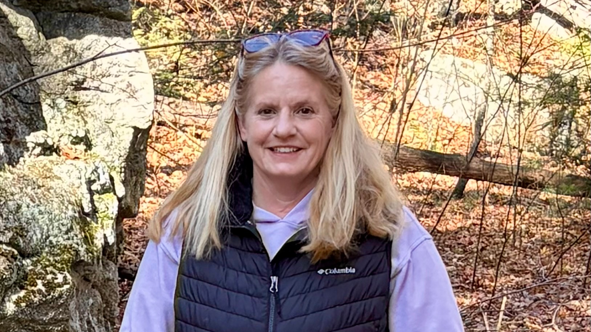 A mature male business owner reviewing paperwork while sitting at desk in an office