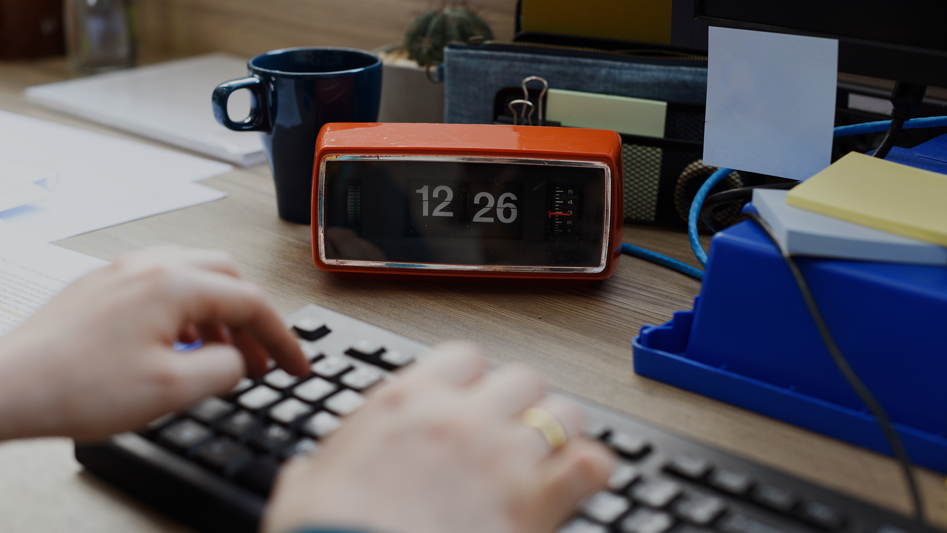 A mature male business owner reviewing paperwork while sitting at desk in an office