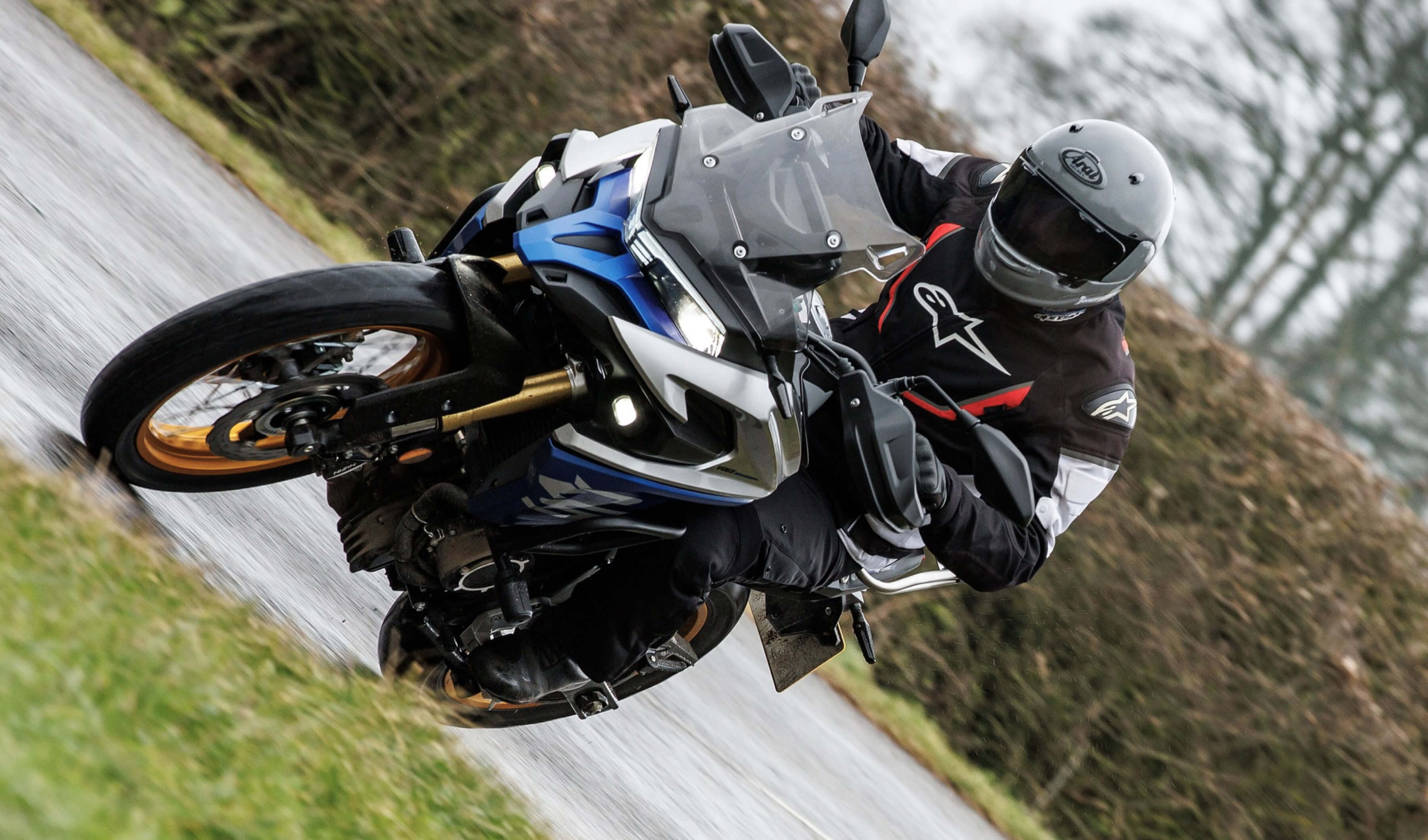 A man riding his Voge motorcycle in a dusty road