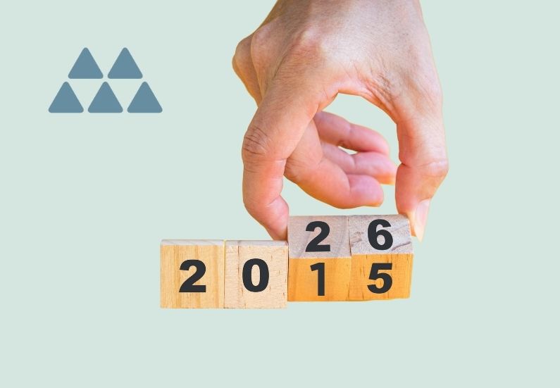 Hand turns wooden blocks with dates from 2015 to 2026