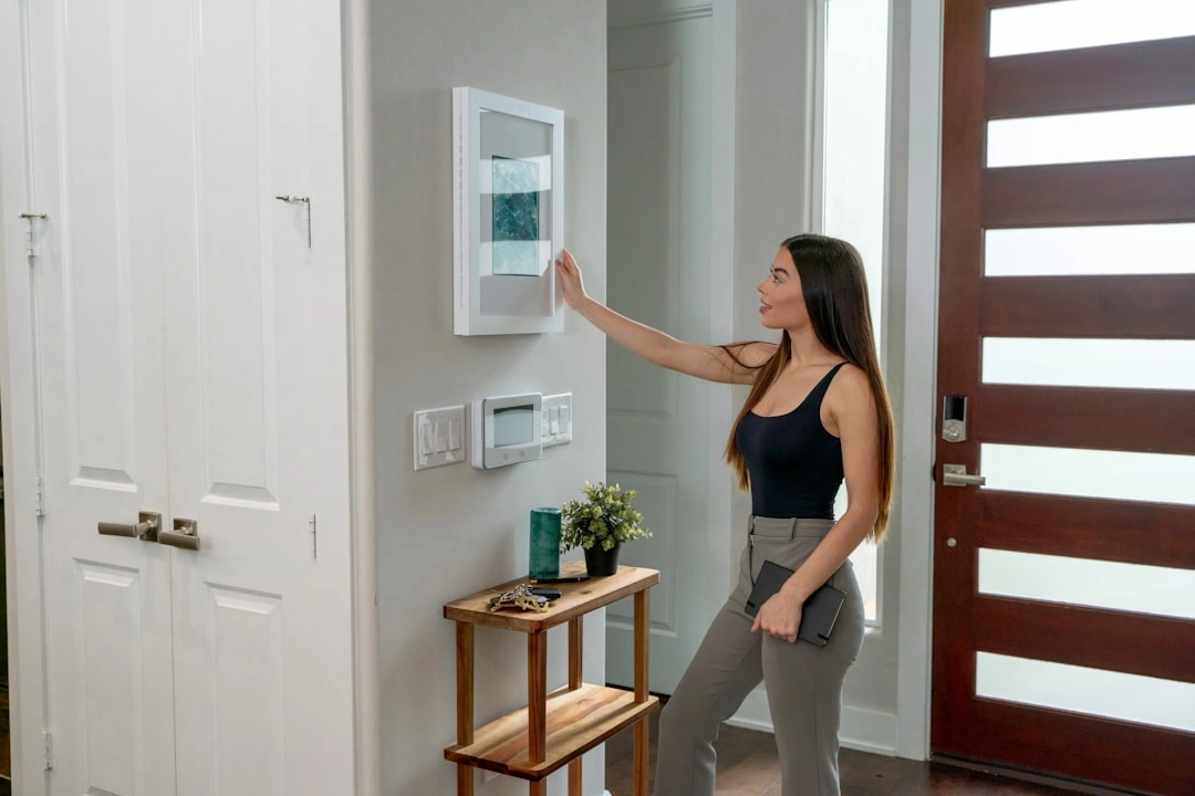 Frustrated homeowner checking a digital thermostat in a warm house - average lifespan of an hvac system in texas