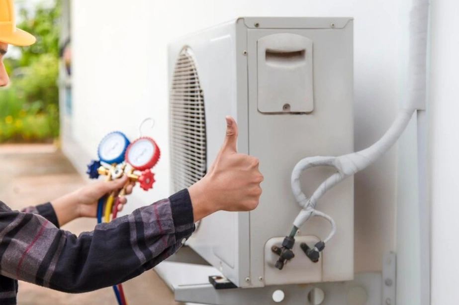 HVAC technician pointing to the safety controls and integrated leak sensors inside a modern A2L cabinet