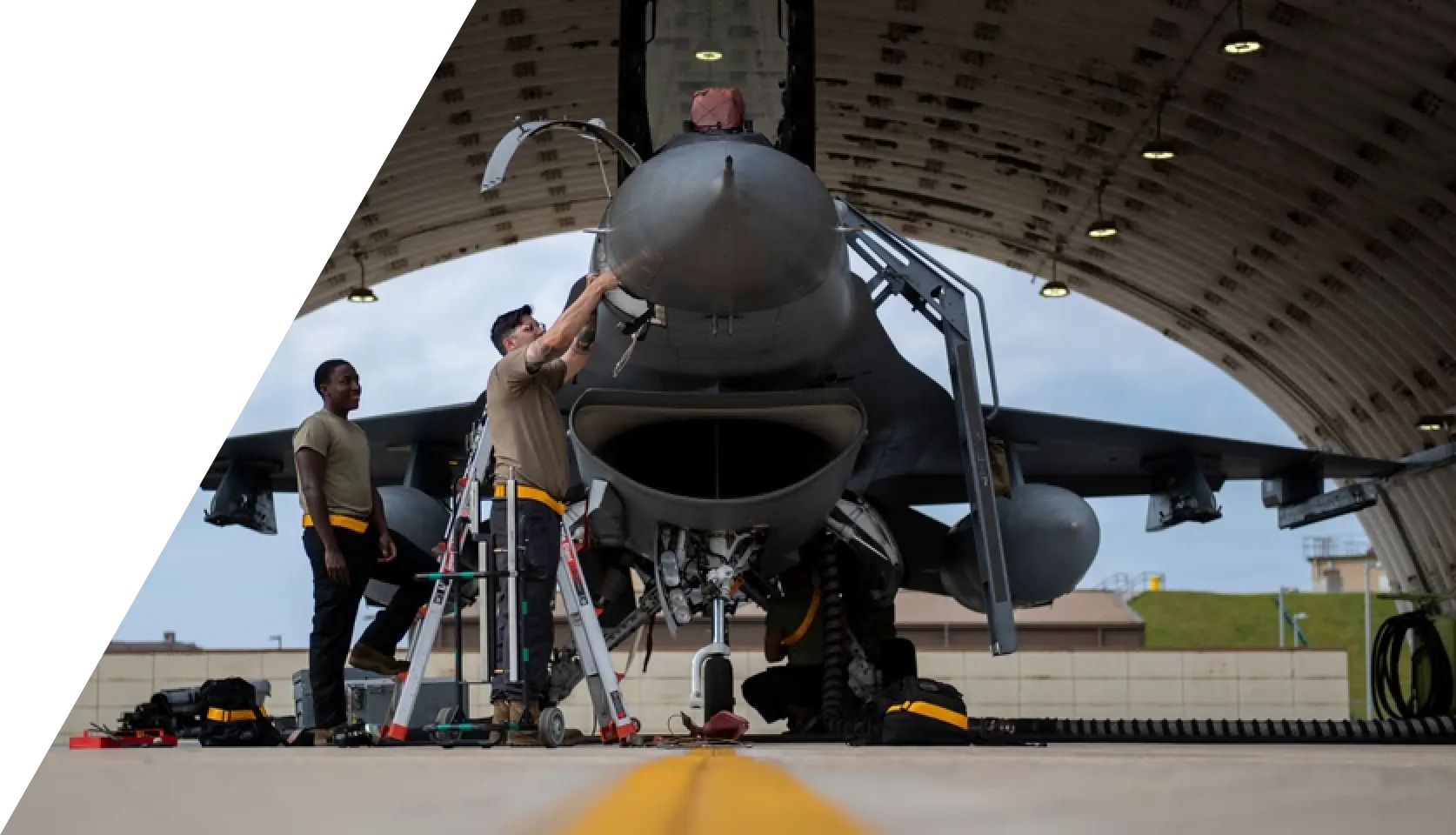 Technicians working on a military aircraft