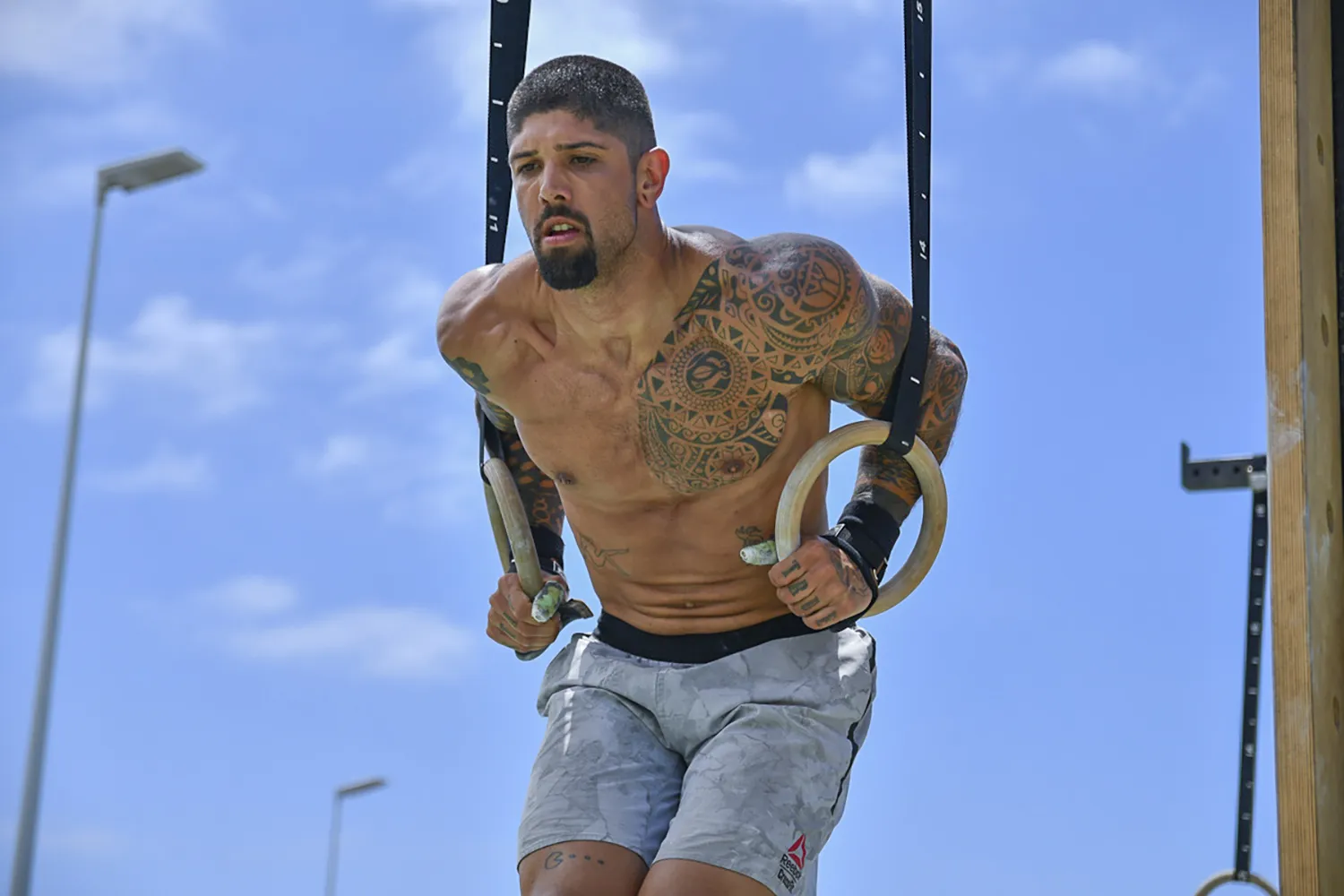 A man doing ring muscle up, at Madeira Games CrossFit event.