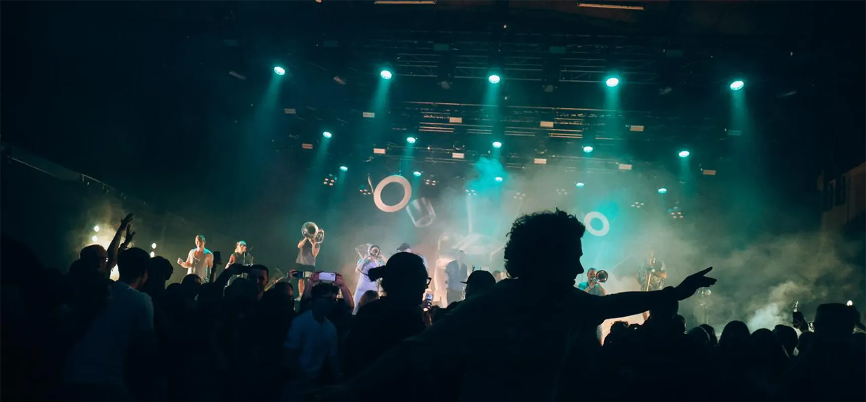 Das bild zeigt ein Konzert, bei dem eine band auf der bühne Performt mit Lichttechnik von photon