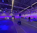 A race track in an exhibition hall illuminated by light towers for a TV show, by photon