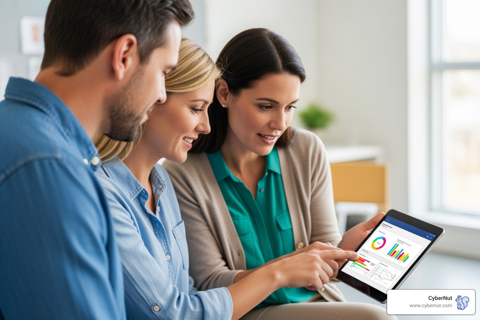 Image of a parent and teacher discussing a student's progress on a tablet - What to Know About the NC Identity Theft Protection Act for K–12