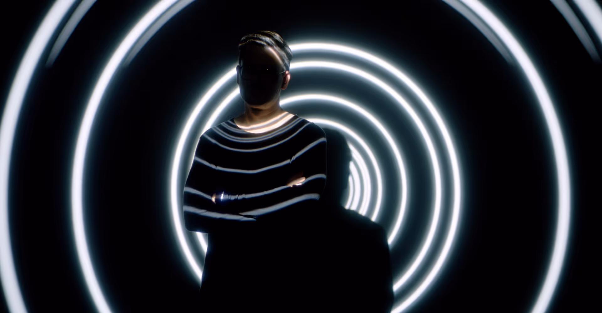 Silhouette of a man in front of a spiral light projection — atmospheric image for Volvo eZone video spot, produced by the Viennese agency Achtzehn Grad for Volvo Austria.