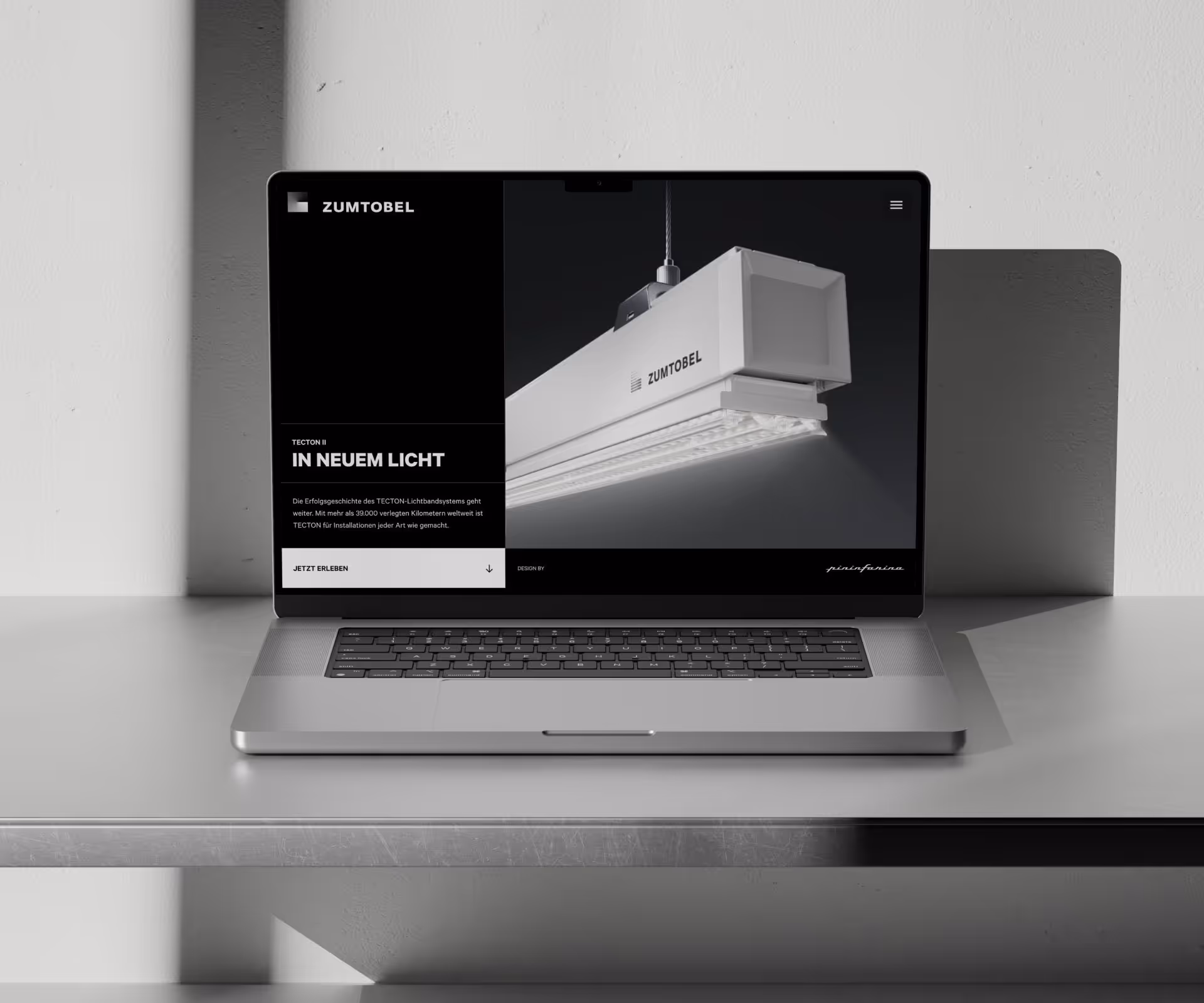 Laptop with an open TECTON II landing page from Zumtobel, designed by Webflow Premium Partner Achzehn Grad in Webflow, shows a close-up of a modern lighting system.