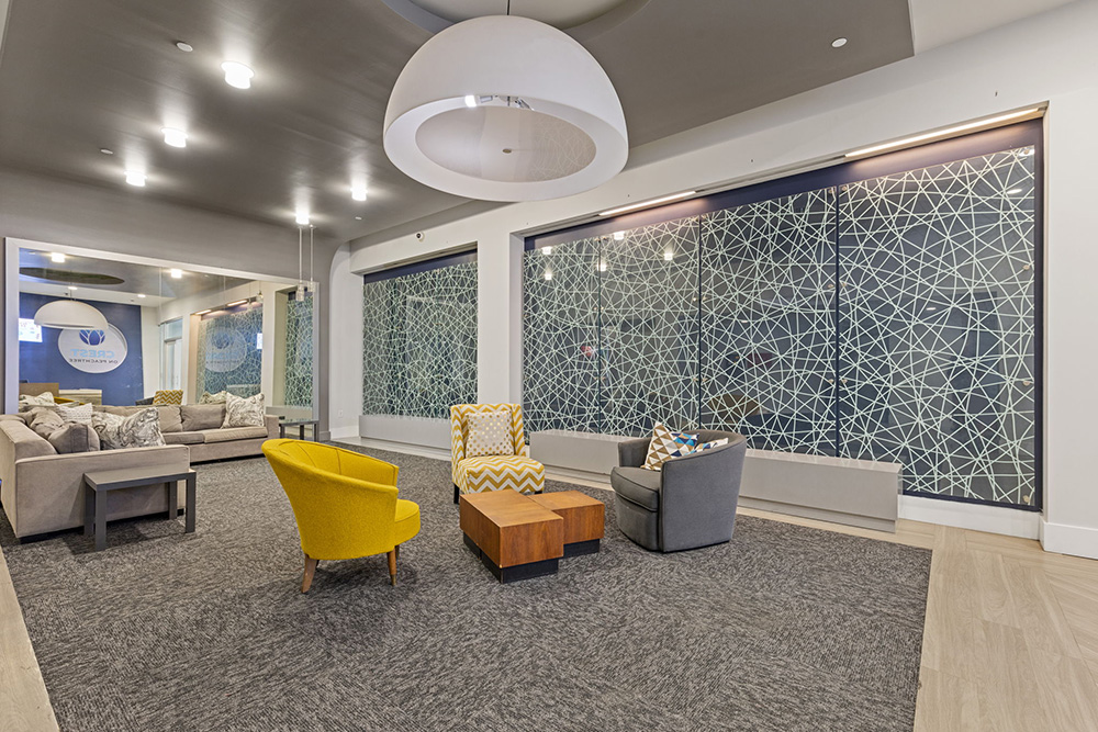 lobby of apartment complex with modern art and furniture 