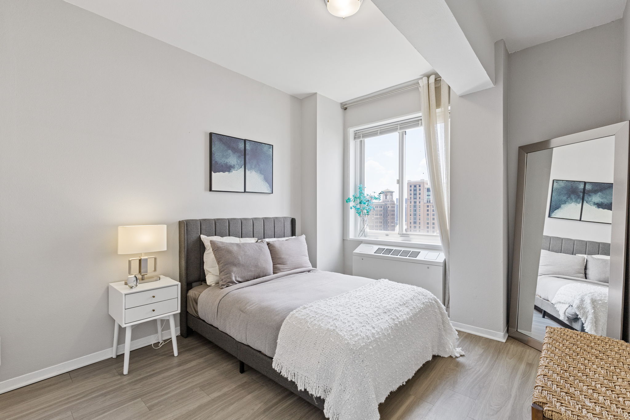 bedroom with window and mirror 