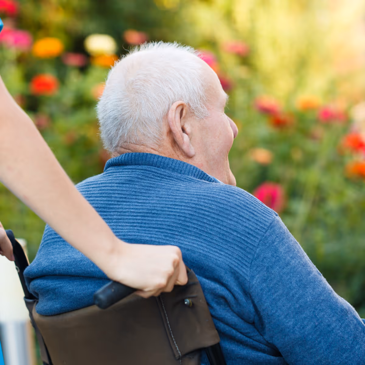 lady pushing elderly man in a wheelchair