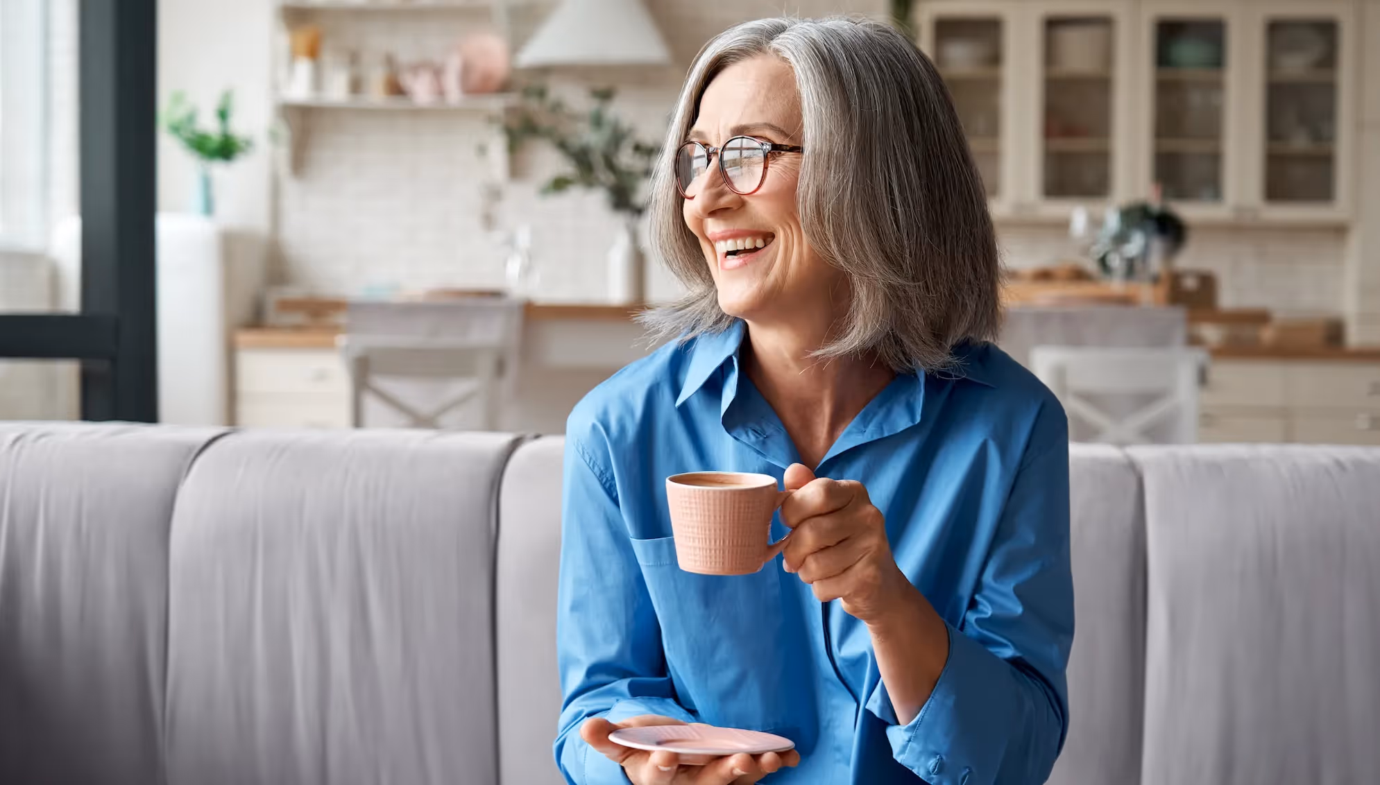 Woman Smiling on Couch Stock Photo