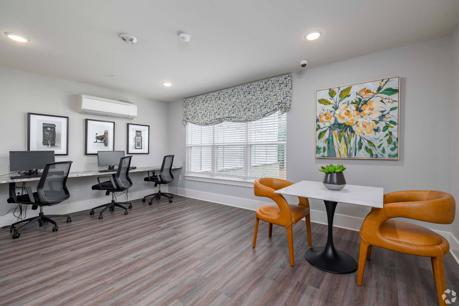 Business center with desks with computers and chairs