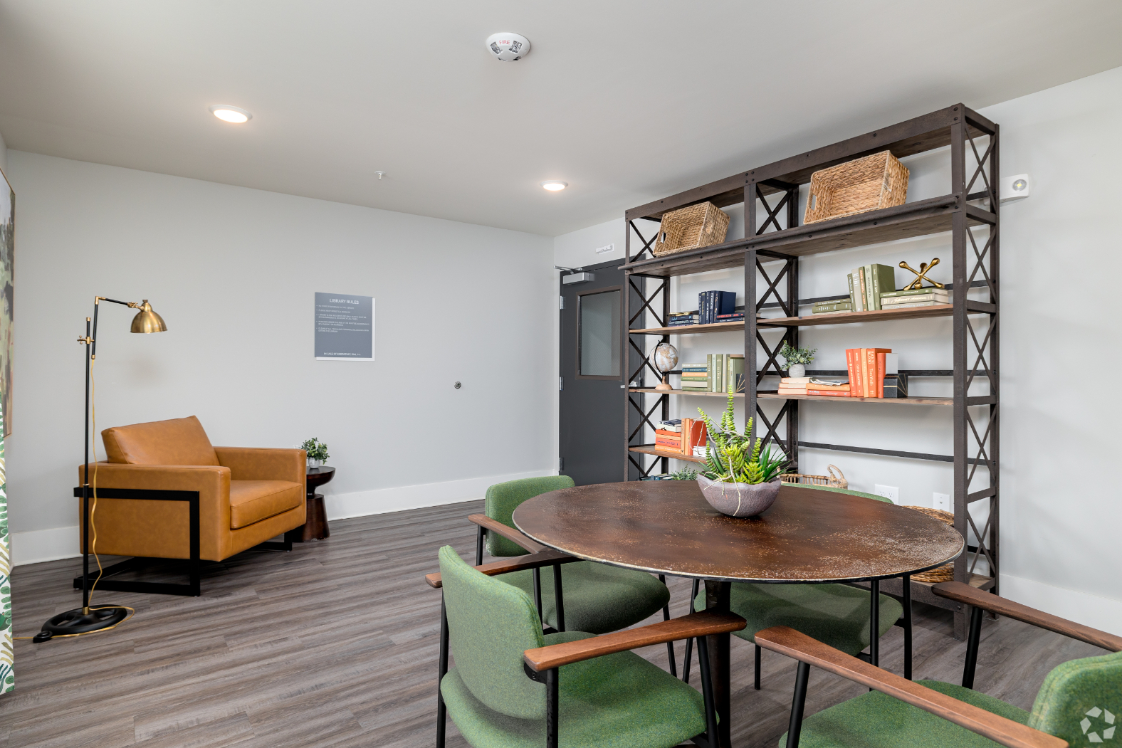 Lounge area with bookshelf, tables and chairs