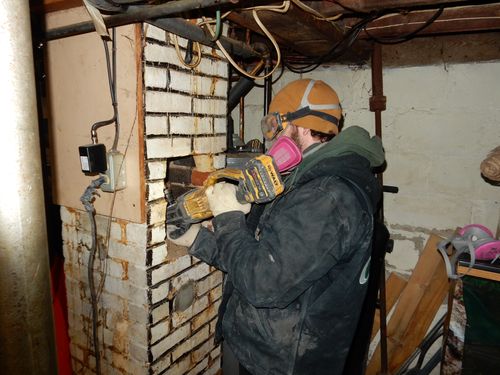 A chimney working is working on a chimney from the bottom