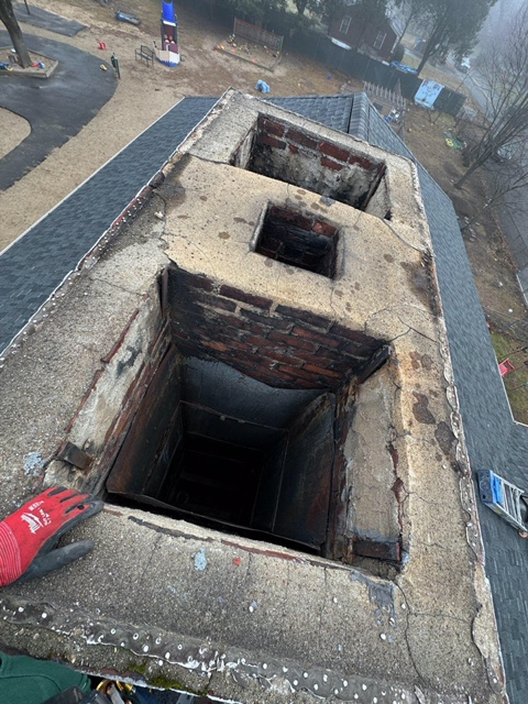 Cracked concrete chimney crown around a clay flue tile