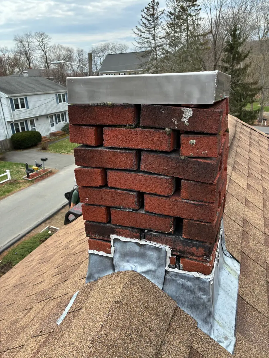 Brick chimney with missing and crumbling mortar joints
