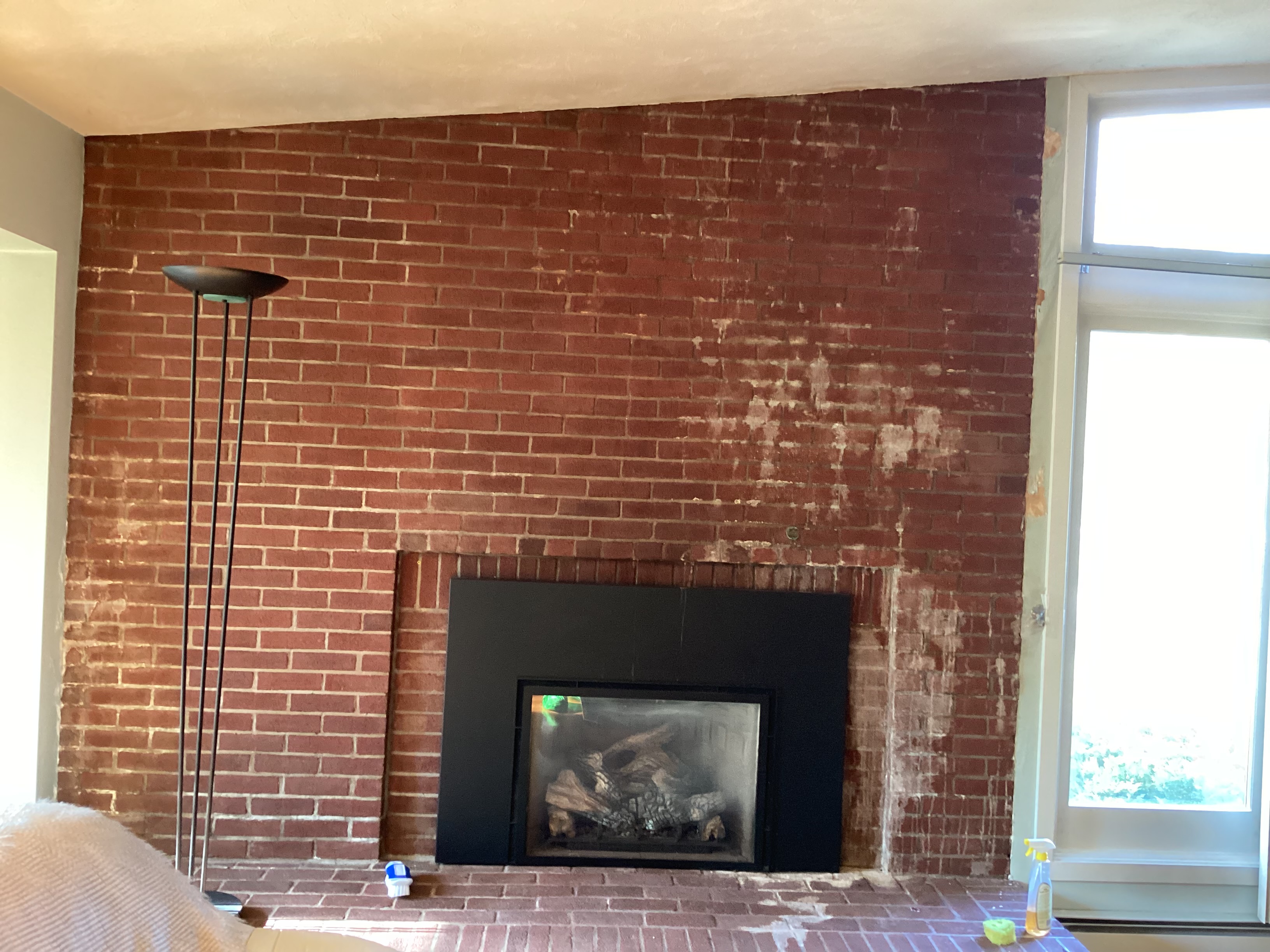 White efflorescence stains running down chimney brick