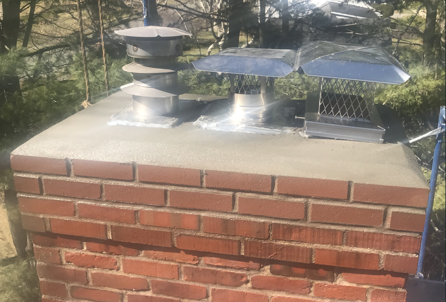 Chimney with a newly rebuilt crown and new chimney caps
