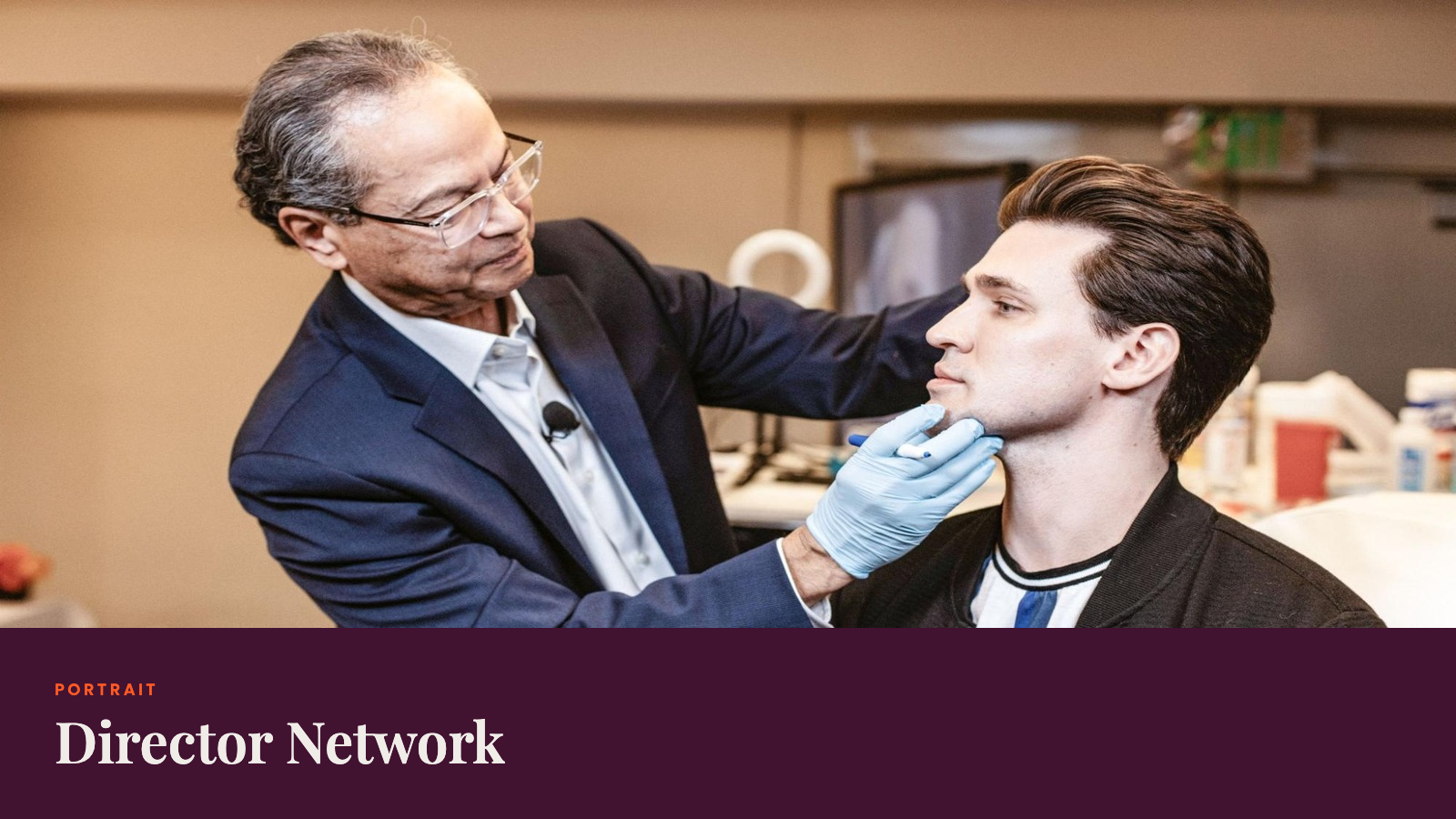 A senior physician assessing a male client's face during a consultation