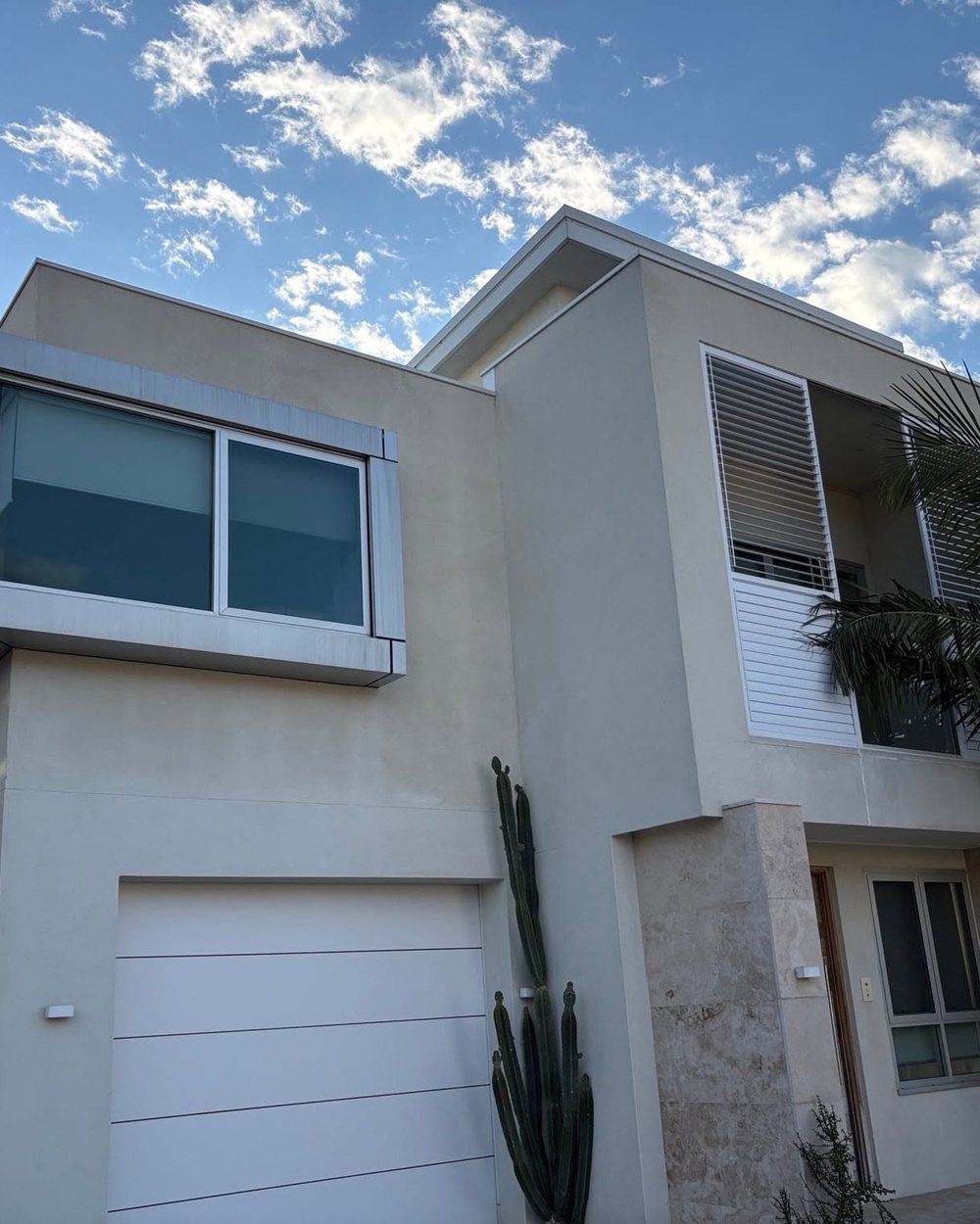 The same rendered wall after a low-pressure soft wash, returned to an even clean finish.