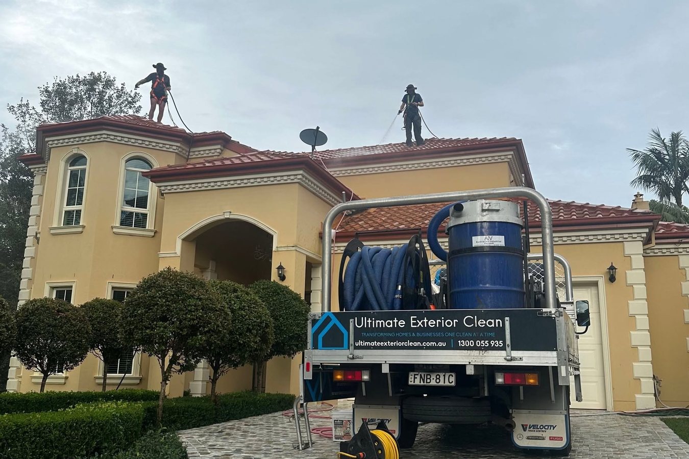 Ultimate Exterior Clean truck with gutter vacuum unit at a Sydney home while technicians work on the roof.