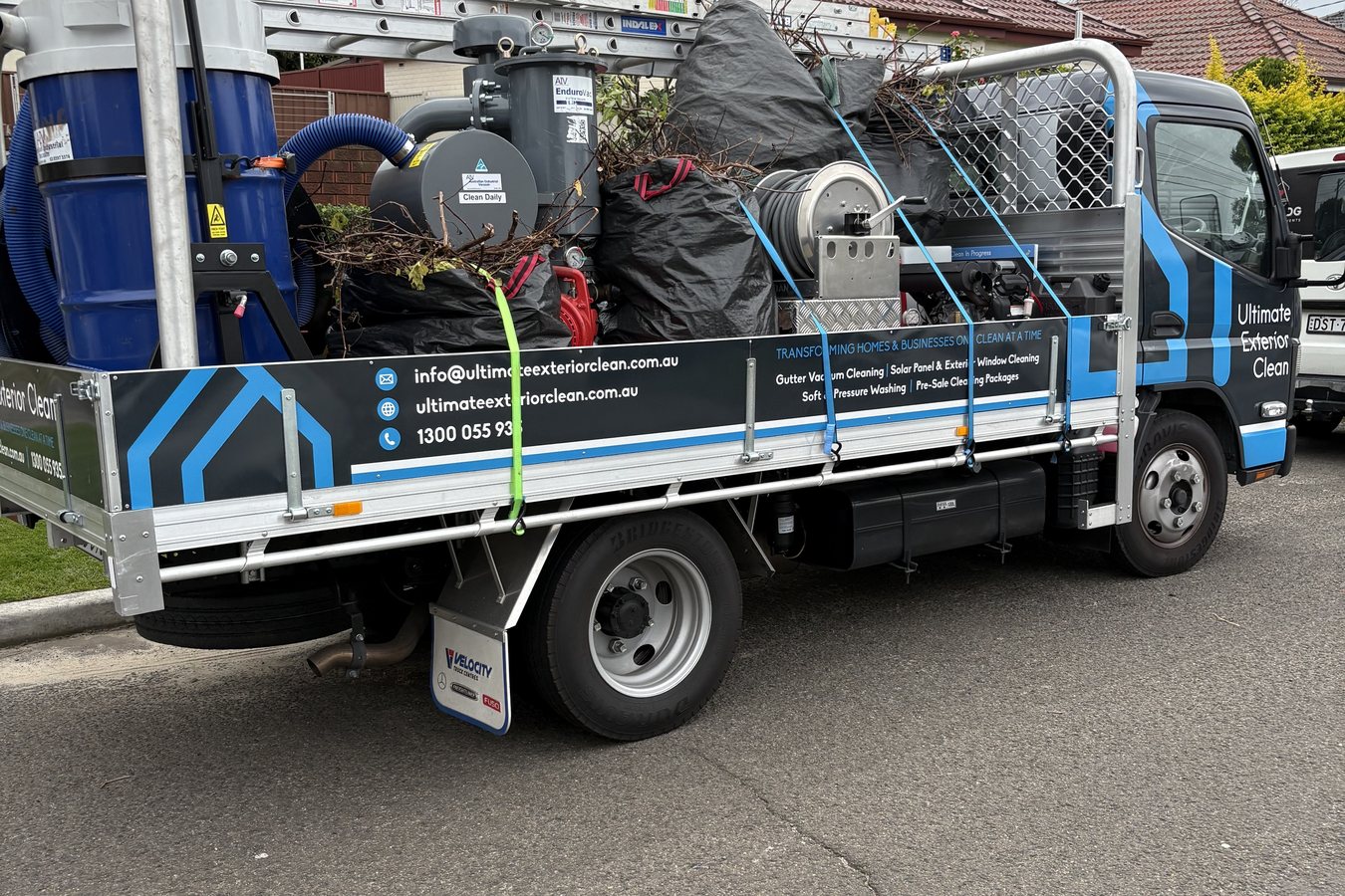 Ultimate Exterior Clean truck loaded with water tanks, hose reels and cleaning equipment.