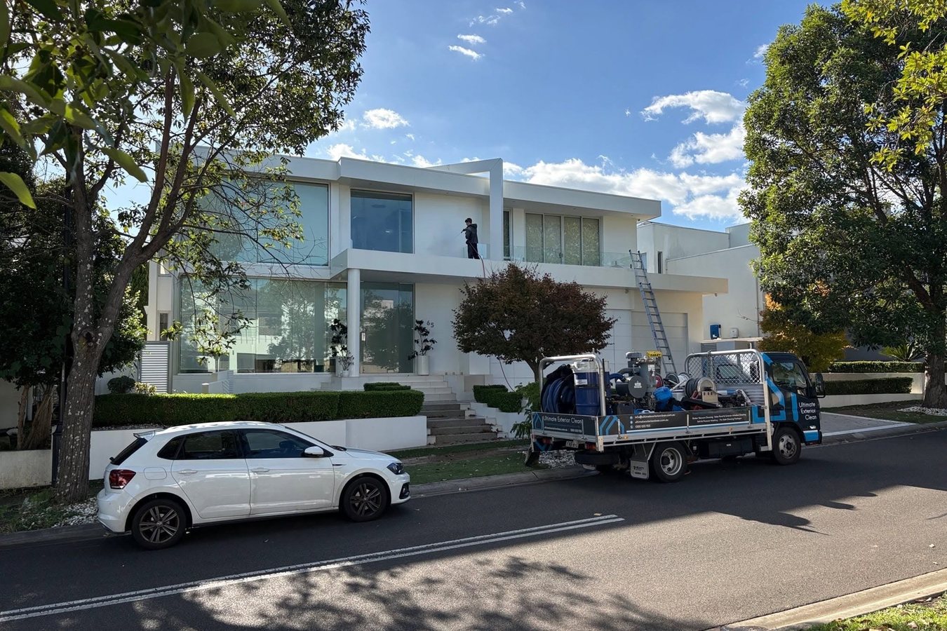 Modern Sydney home with a large glazed frontage and the Ultimate Exterior Clean truck at the kerb.