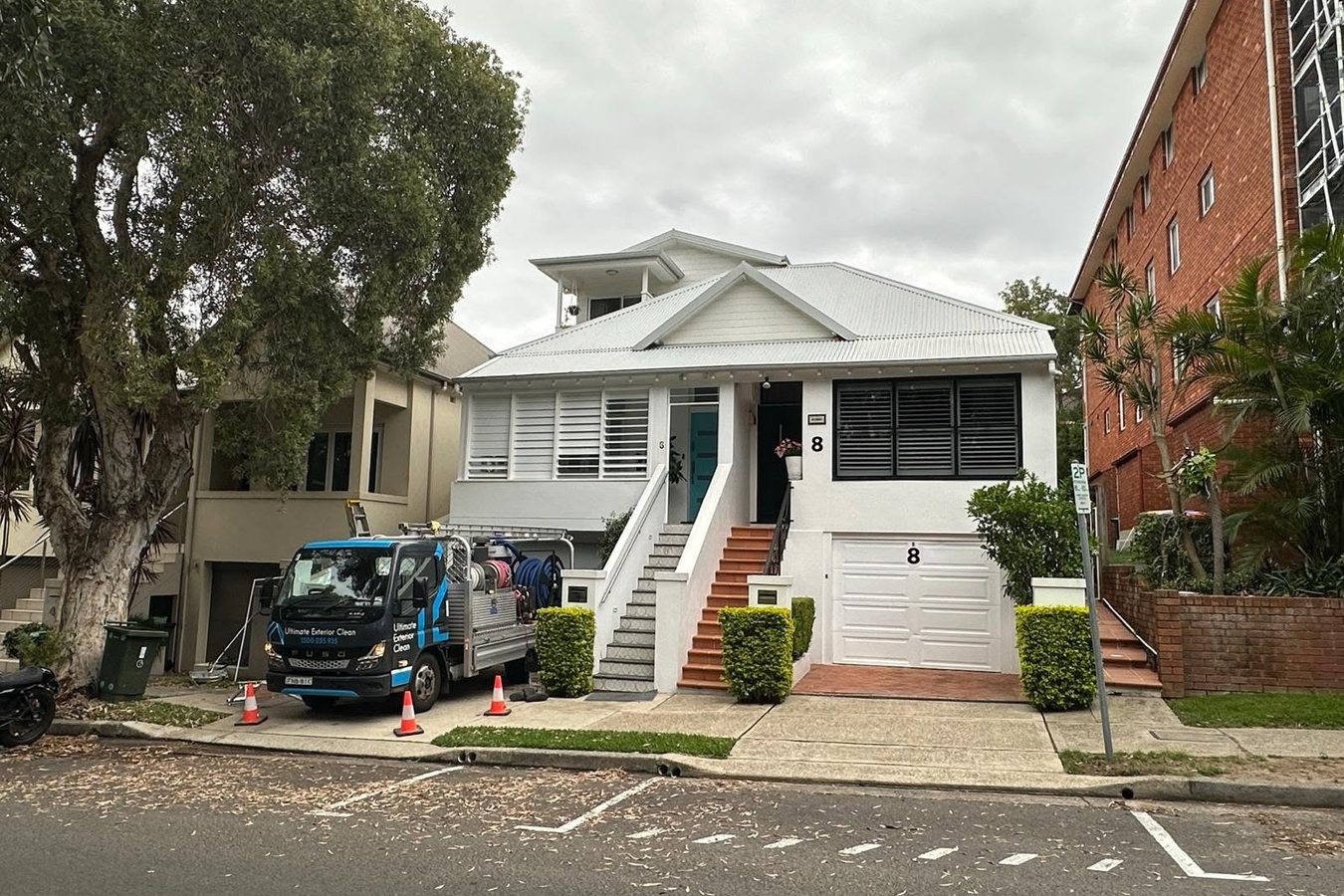 Ultimate Exterior Clean vehicle parked outside a white weatherboard Sydney building during a job.