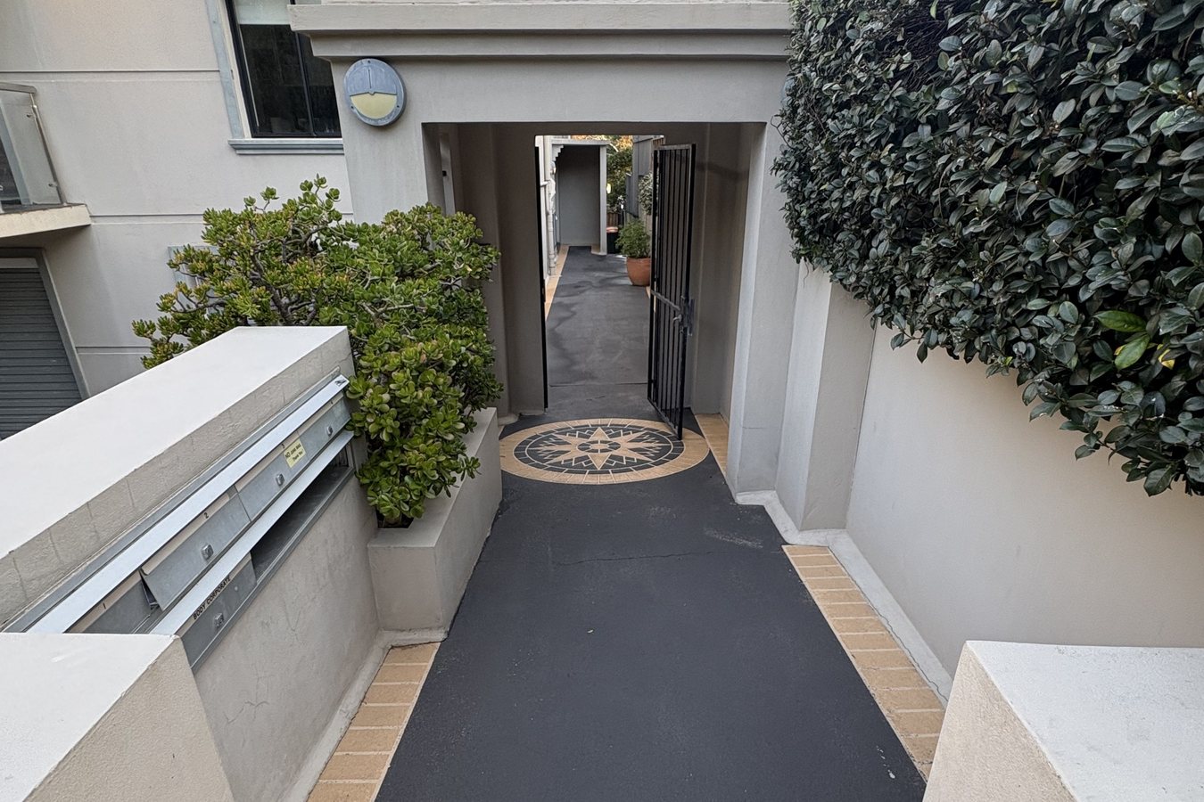 Cleaned entry path with mosaic inlay leading to a Sydney home.